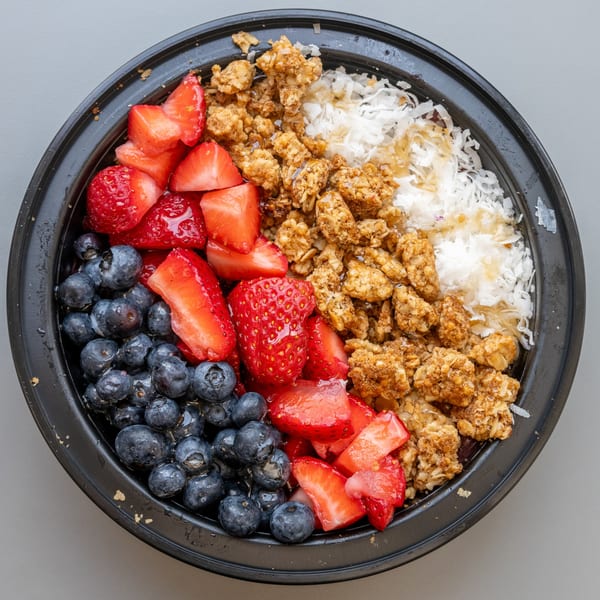 A healthy Blend Riverwalk acai bowl with blueberries, strawberries, granola, and shredded coconut.